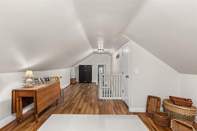 bonus room featuring wood-type flooring and vaulted ceiling