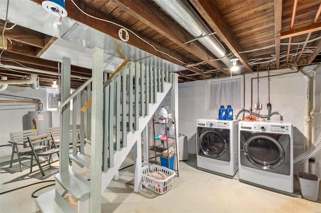 basement with washing machine and clothes dryer and water heater