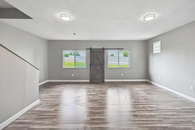 spare room featuring hardwood / wood-style flooring and a barn door