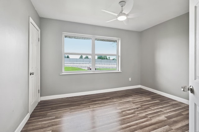 unfurnished room featuring dark hardwood / wood-style flooring and ceiling fan