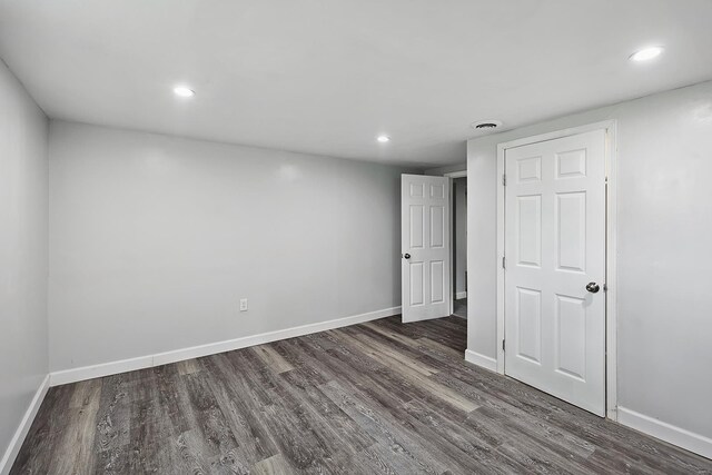 empty room with dark wood-type flooring