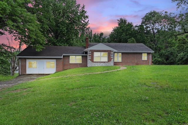 ranch-style home with a lawn