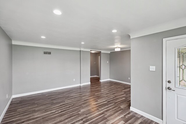 basement featuring dark hardwood / wood-style flooring