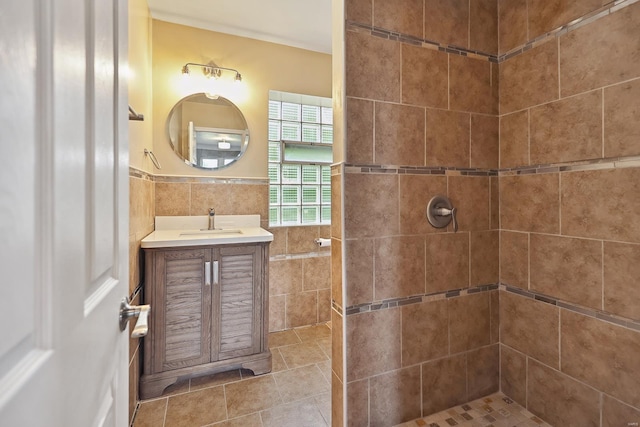 bathroom featuring vanity, tile walls, and a tile shower