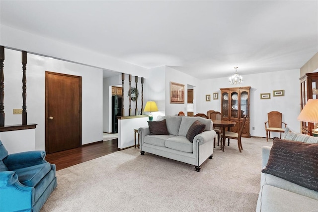 living area with an inviting chandelier and carpet flooring