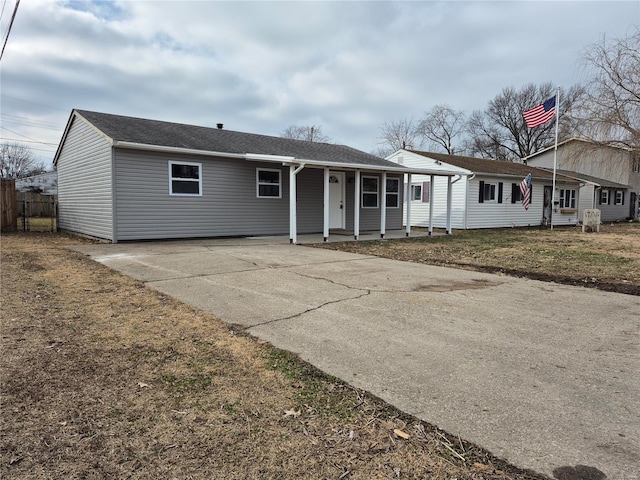 single story home with a porch and a front yard