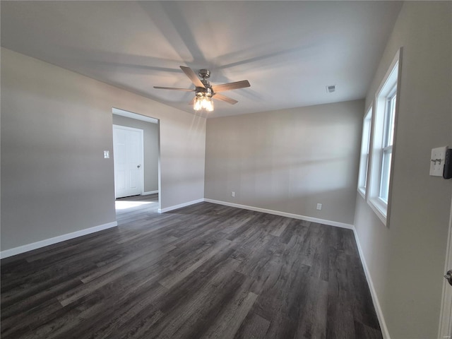 spare room featuring ceiling fan and dark hardwood / wood-style floors