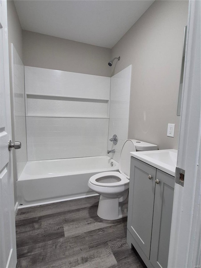 full bathroom with shower / bath combination, wood-type flooring, vanity, and toilet