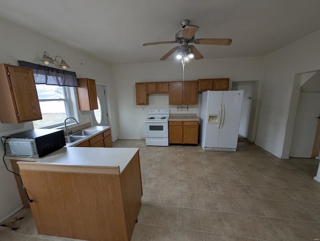 kitchen with ceiling fan, white appliances, and sink