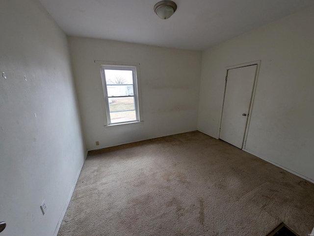 unfurnished room with light carpet