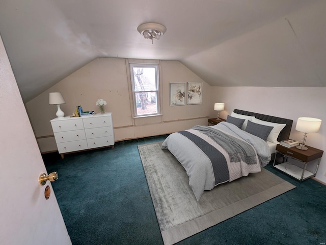 bedroom with vaulted ceiling and dark colored carpet