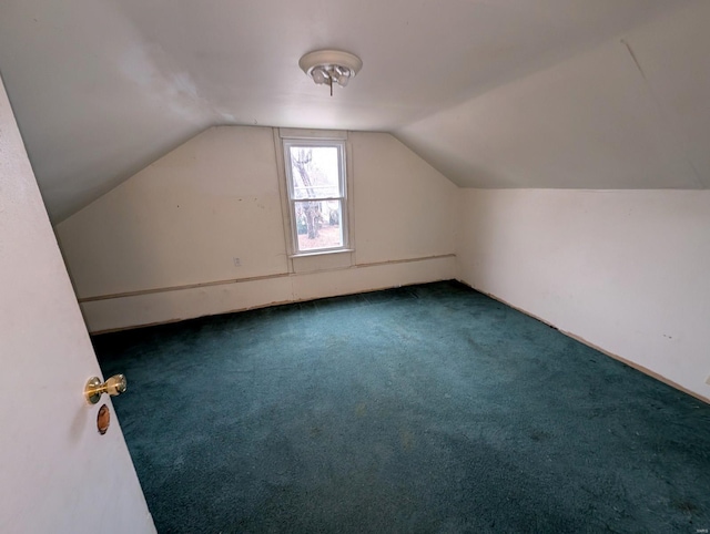 bonus room featuring lofted ceiling and dark carpet