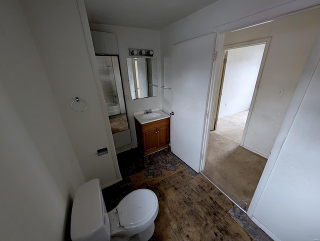 bathroom with vanity, a shower, and toilet