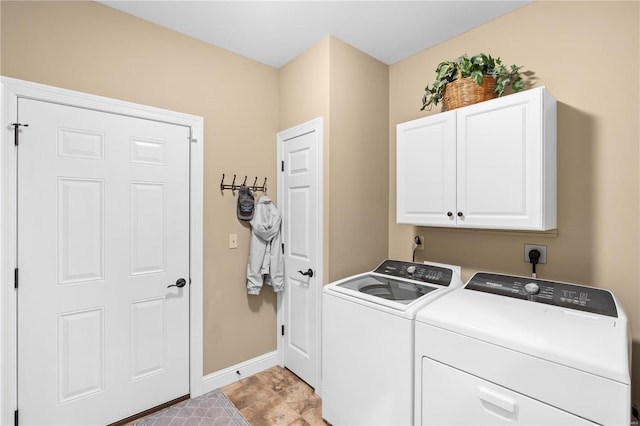 laundry room featuring independent washer and dryer and cabinets