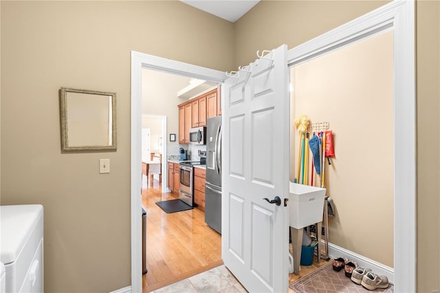 washroom featuring washer and clothes dryer