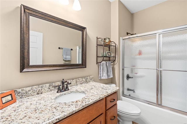 full bathroom with vanity, shower / bath combination with glass door, and toilet