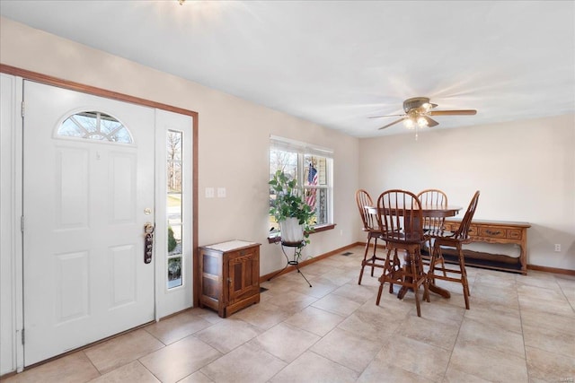 dining space featuring light tile patterned flooring, ceiling fan, and baseboards