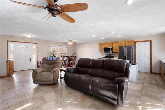 living room featuring recessed lighting, baseboards, and ceiling fan