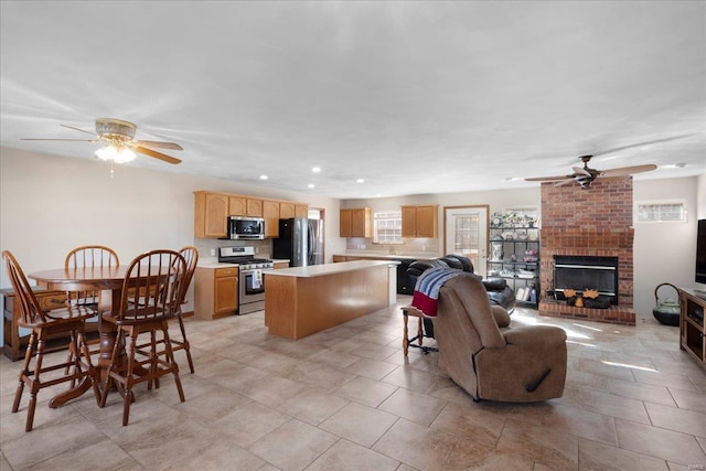 interior space with recessed lighting, a fireplace, and a ceiling fan