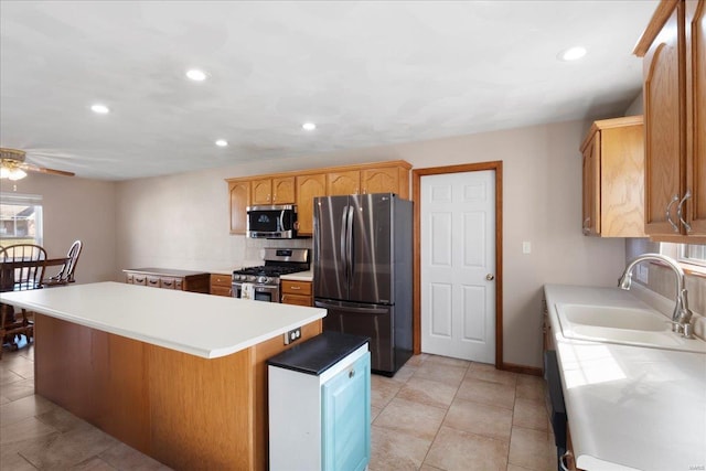 kitchen with a sink, appliances with stainless steel finishes, recessed lighting, and light countertops