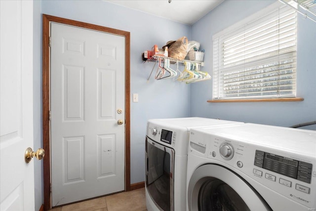 laundry room featuring washer and dryer, laundry area, and light tile patterned floors