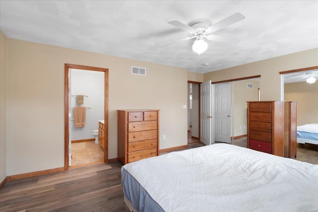 bedroom featuring visible vents, baseboards, and wood finished floors