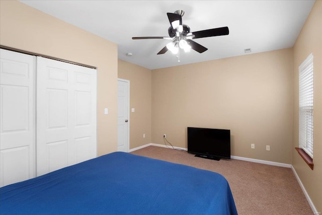 unfurnished bedroom with visible vents, baseboards, carpet flooring, a closet, and a ceiling fan