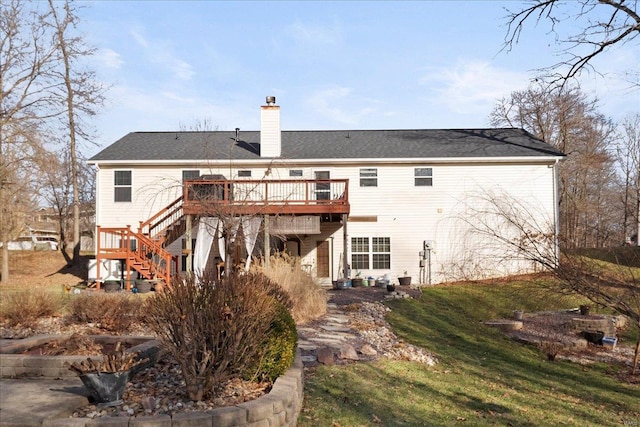 rear view of house with stairs, a yard, a chimney, and a wooden deck