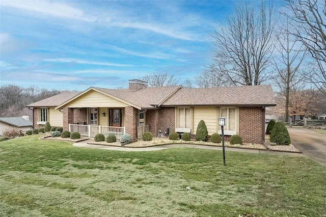 single story home with covered porch and a front yard