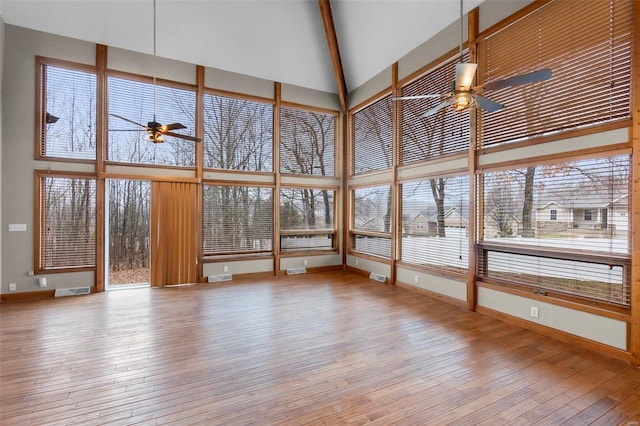 unfurnished sunroom with plenty of natural light and ceiling fan