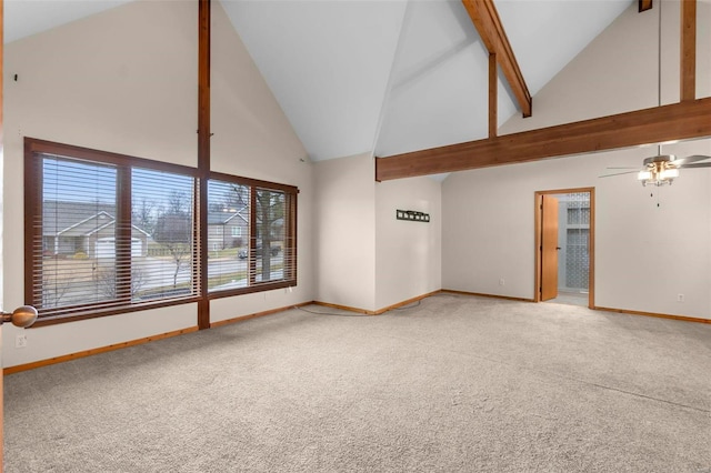 unfurnished living room with beamed ceiling, high vaulted ceiling, ceiling fan, and carpet