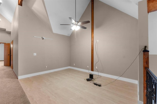 unfurnished living room featuring high vaulted ceiling and ceiling fan