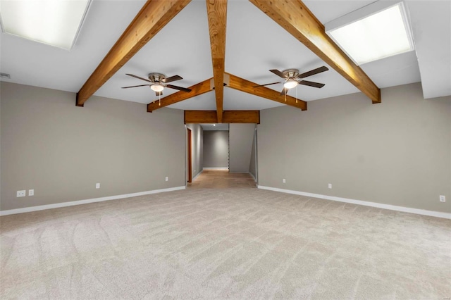 unfurnished living room featuring light carpet, ceiling fan, and beamed ceiling