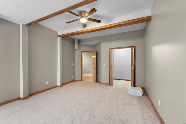 unfurnished bedroom featuring ceiling fan, light carpet, and beam ceiling