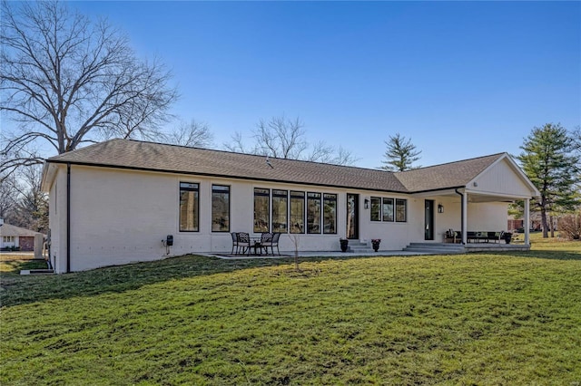 rear view of house with a lawn and a patio