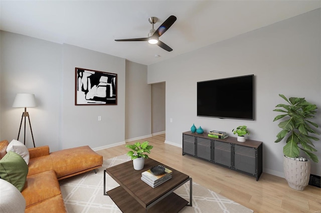 living room with hardwood / wood-style floors and ceiling fan