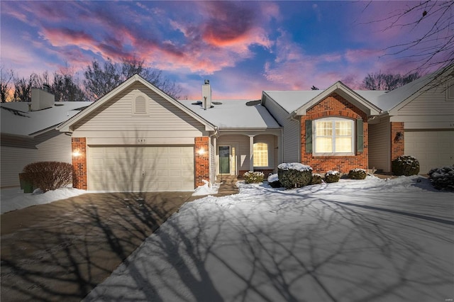 single story home with aphalt driveway, brick siding, a chimney, and an attached garage