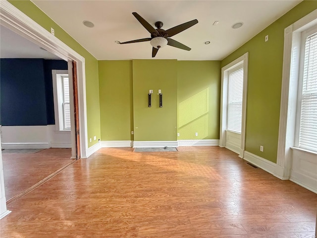 spare room with ceiling fan and light hardwood / wood-style flooring