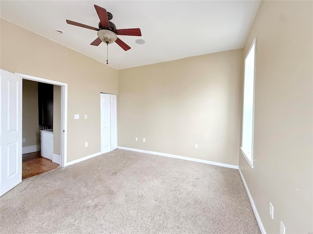 unfurnished bedroom with ceiling fan, carpet floors, and a closet