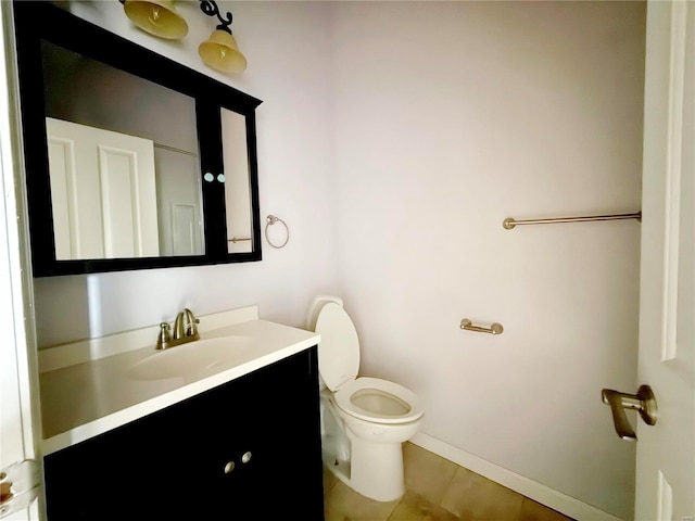 bathroom featuring tile patterned flooring, vanity, and toilet