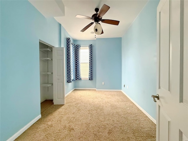 unfurnished bedroom with light carpet, ceiling fan, and a closet