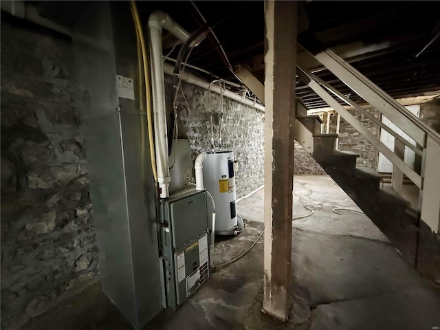 utility room with heating unit and electric water heater