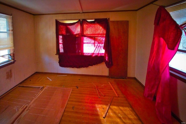 unfurnished dining area featuring wood-type flooring and ornamental molding