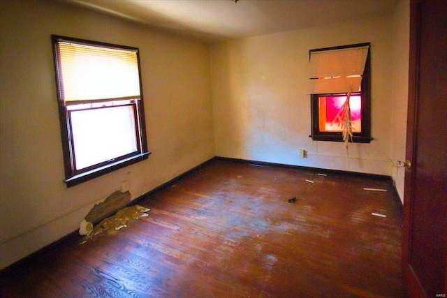 empty room with dark hardwood / wood-style flooring