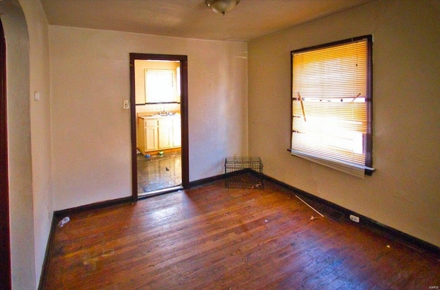 empty room featuring dark hardwood / wood-style flooring