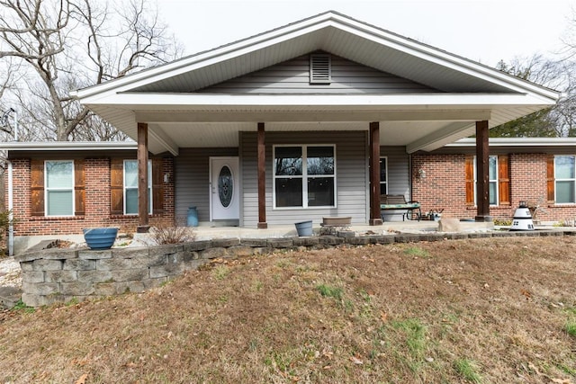 view of front of property with a porch and a front lawn