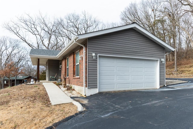 view of side of home featuring a garage and covered porch