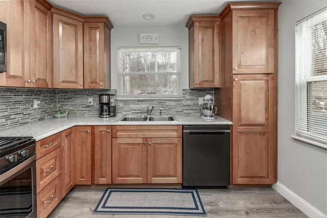 kitchen with sink, light hardwood / wood-style flooring, backsplash, and black appliances