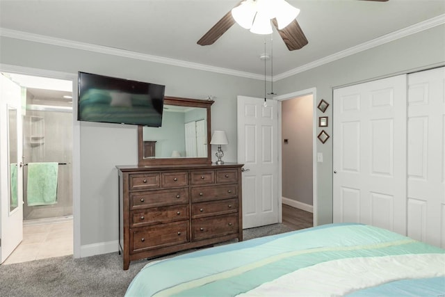 bedroom featuring connected bathroom, light colored carpet, ceiling fan, crown molding, and a closet