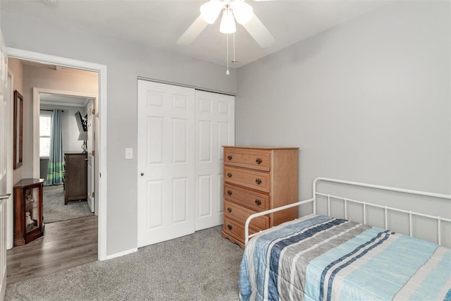 carpeted bedroom featuring ceiling fan and a closet